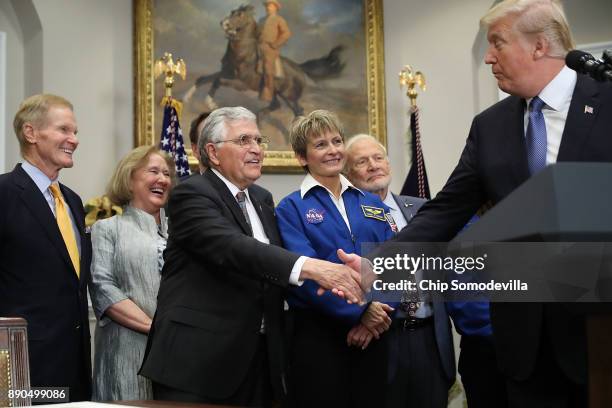 President Donald Trump shakes hands with Apollo 17 astronaut Jack Schmitt before signing 'Space Policy Directive 1' during a ceremony with Sen. Bill...