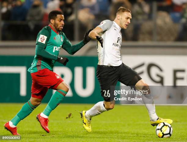 Rade Dugalic of FC Tosno and Jefferson Farfan of FC Lokomotiv Moscow vie for the ball during the Russian Football League match between FC Tosno and...