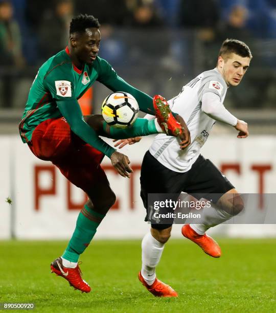 Aleksandr Karnitsky of FC Tosno and Eder of FC Lokomotiv Moscow vie for the ball during the Russian Football League match between FC Tosno and FC...