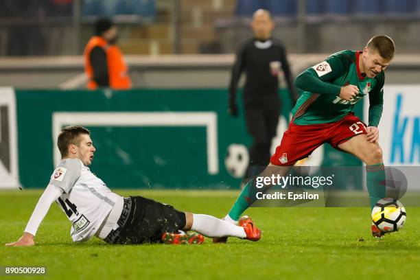 Aleksandr Karnitsky of FC Tosno and Igor Denisov of FC Lokomotiv Moscow vie for the ball during the Russian Football League match between FC Tosno...