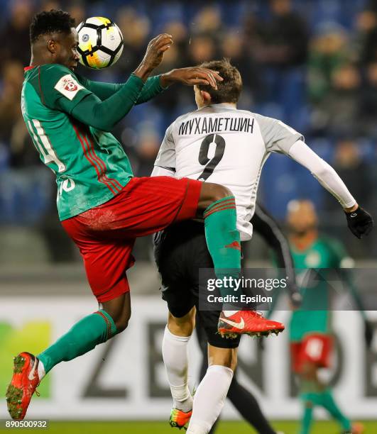 Rustem Mukhametshin of FC Tosno and Eder of FC Lokomotiv Moscow vie for a header during the Russian Football League match between FC Tosno and FC...