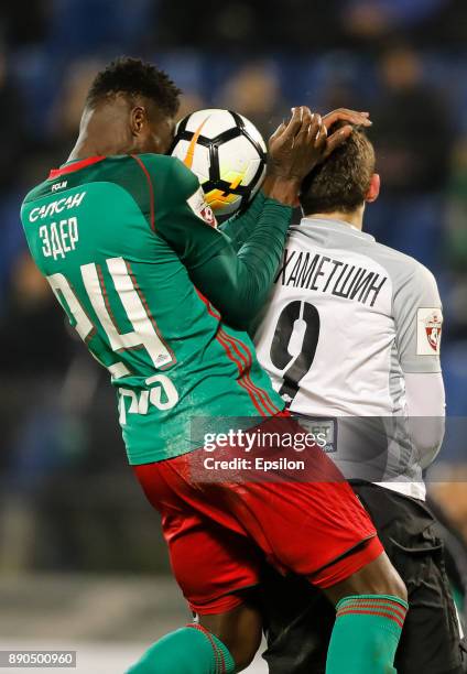 Rustem Mukhametshin of FC Tosno and Eder of FC Lokomotiv Moscow vie for a header during the Russian Football League match between FC Tosno and FC...