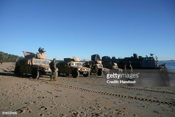 Marines Humvee four-wheel drive vehicles and a US Navy Landing Craft Air Cushion position themselves for the Talisman Saber 2009 joint exercise on...