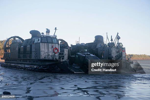 Marines Humvees disembark from a Navy Landing Craft Air Cushion to position themselves for the Talisman Saber 2009 joint exercise on July 15, 2009 on...