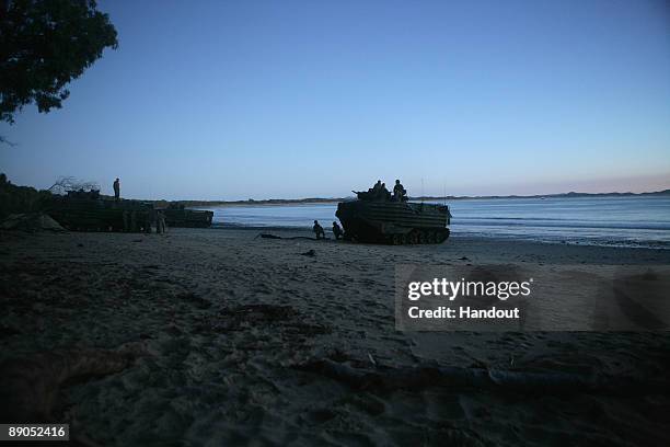 Amphibious Assault Vehicles emerge onto the beach from the amphibious assault ship USS Essex to position themselves for the Talisman Saber 2009 joint...