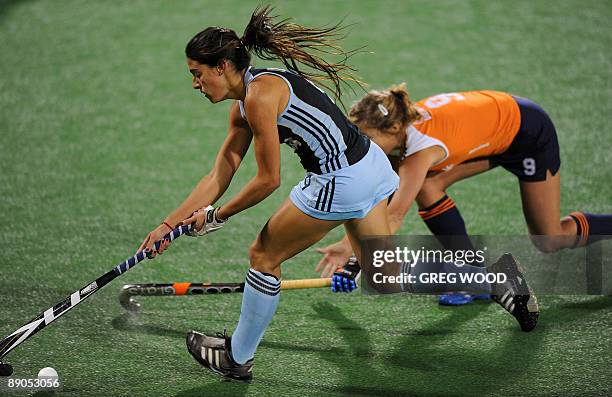 Carla Dupuy of Argentina breaks clear of Wieke Dijkstra of the Netherlands during their Women's Champions Trophy hockey match in Sydney on July 16,...