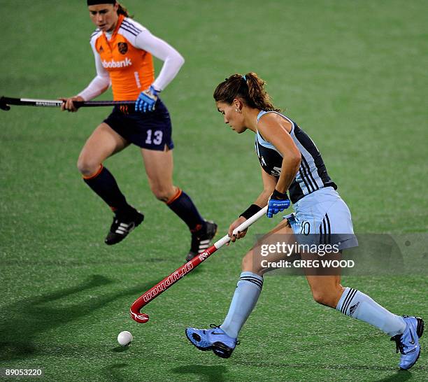 Minke Smeets of the Netherlands runs in to stop Soledad Garcia of Argentina during their Women's Champions Trophy hockey match in Sydney on July 16,...