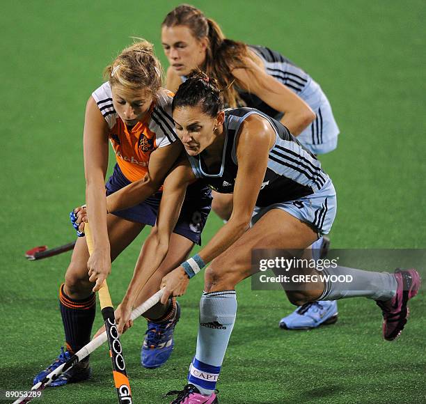 Argentina's captain Luciana Aymar vies with Wieke Dijkstra of the Netherlands during their Women's Champions Trophy hockey match in Sydney on July...