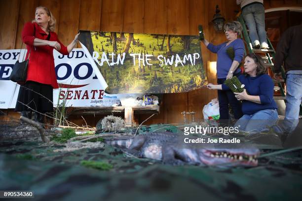 People put together a "swamp" display with toy alligators, snakes and other creatures before the arrival of Republican Senatorial candidate Roy Moore...