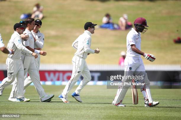 Trent Boult of New Zealand celebrates his 200th test wicket as he dismisses Kraigg Brathwaite of the West Indies R) during day four of the Second...