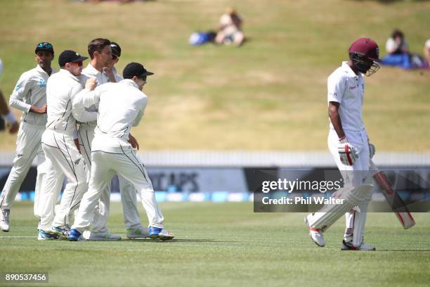 Trent Boult of New Zealand celebrates his 200th test wicket as he dismisses Kraigg Brathwaite of the West Indies R) during day four of the Second...