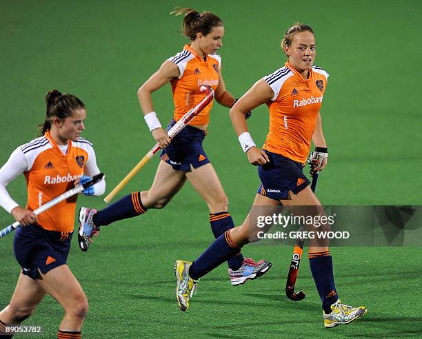 Maartje Pauman of the Netherlands smiles to her coach as she runs back to the centre to re-start after scoring a goal against Argentina during the...