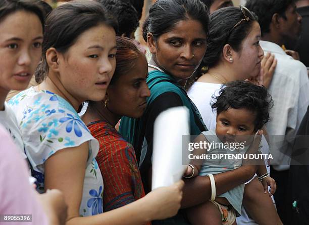 Indian bus passengers stranded due to a political strike queue for tickets at the Sikkim Bus Terminus in Siliguri on July 16 the fourth day of an...