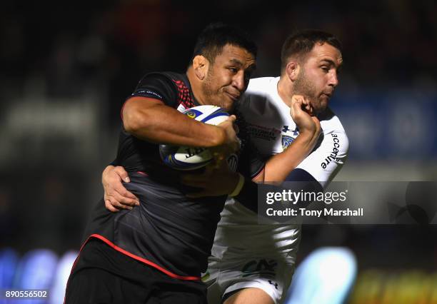 Mako Vanipola of Saracens is tackled by Scott Spedding of ASM Clermont Auvergne during the European Rugby Champions Cup match between Saracens and...