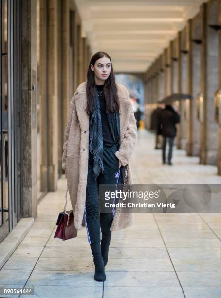 Model Julia Leineweber wearing a H&M teddy coat, Mango bag, Adidas jogger pants, Zara sweater, H&M boots, Gucci scarf on December 11, 2017 in...