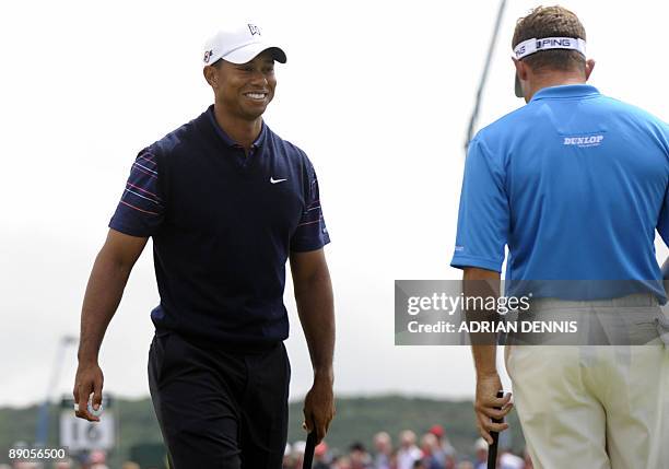 Golfer Tiger Woods and English golfer Lee Westwood stand on the 14th green on the first day of the 138th British Open Championship at Turnberry Golf...