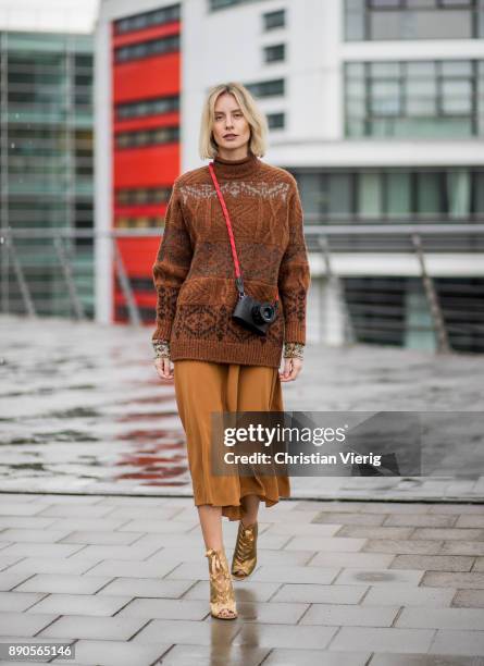 Lisa Hahnbueck wearing a brown knit Mulberry, a brown Rochas dress, golden Gianvito Rossi high heels on December 11, 2017 in Duesseldorf, Germany.