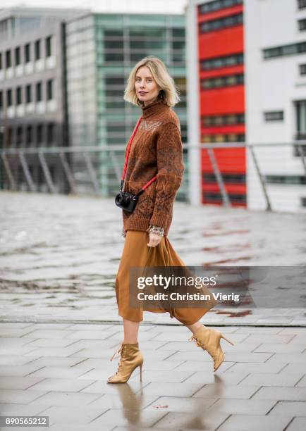 Lisa Hahnbueck wearing a brown knit Mulberry, a brown Rochas dress, golden Gianvito Rossi high heels on December 11, 2017 in Duesseldorf, Germany.