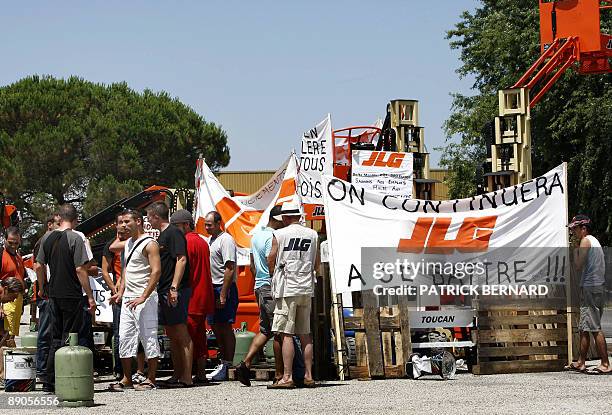 Employees of the JLB plant, where 53 layoffs are planed, gahter near to a barricade on July 16, 2009 in front of the plant in Tonneins, southern...