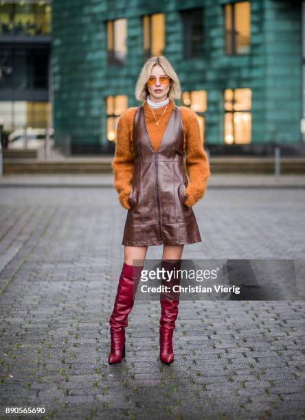 Lisa Hahnbueck wearing brown Chloe dress with zipper, brown Mulberry knit, red Zara overknee boots, Vouge eyewear sunglasses on December 11, 2017 in...