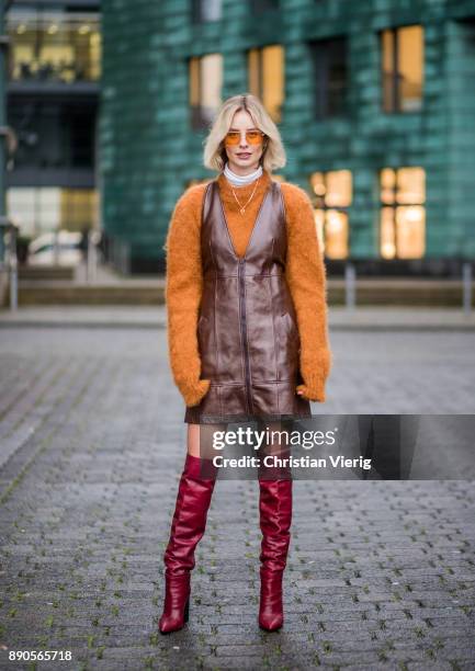 Lisa Hahnbueck wearing brown Chloe dress with zipper, brown Mulberry knit, red Zara overknee boots, Vouge eyewear sunglasses on December 11, 2017 in...