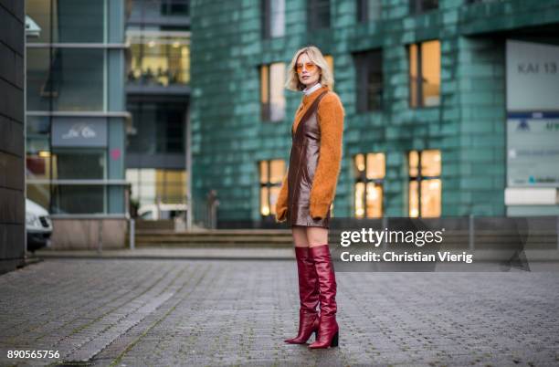 Lisa Hahnbueck wearing brown Chloe dress with zipper, brown Mulberry knit, red Zara overknee boots, Vouge eyewear sunglasses on December 11, 2017 in...