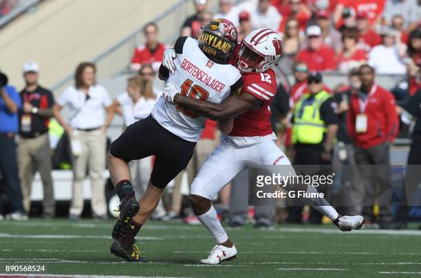 Max Bortenschlager of the Maryland Terrapins is tackled by Natrell Jamerson of the Wisconsin Badgers at Camp Randall Stadium on October 21, 2017 in...