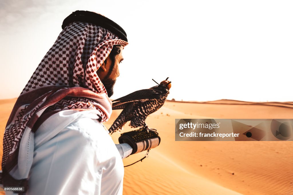 Arabic man in the desert with a falcon