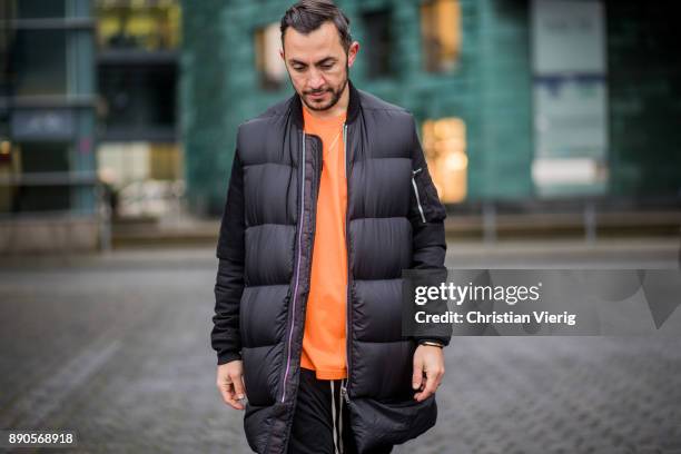 Dima wearing Gucci sneakers, Gucci socks, orange Supreme tshirt, Rick Owens college jacket and Rick Owens down feather vest, black Rick Owens pants...