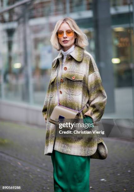 Lisa Hahnbueck wearing green Haider Ackermann dress, flared denim jeans Chloe, green checked Chloe coat, brown Aquazurra x Poppy Delevigne heels,...