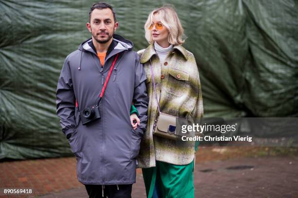 Couple Dima and Lisa Hahnbueck wearing green Haider Ackermann dress, flared denim jeans Chloe, green checked Chloe coat, brown Aquazurra x Poppy...