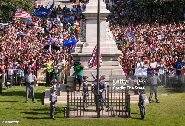 The South Carolina Highway Patrol Honor Guard removes the Confederate Battle Flag from the State House grounds during a ceremony on Friday, July 10...