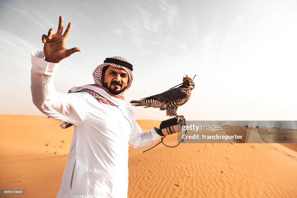 Arabic man in the desert with a falcon