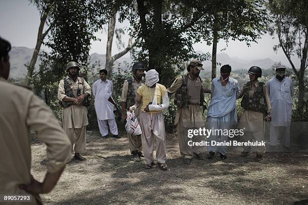 Suspected Taliban militants are held by the Pakistan Military at a Military outpost, after capturing them on a security sweep of the area, on July...