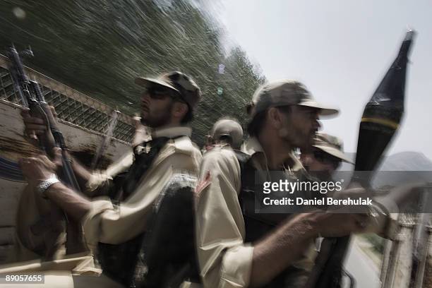 Pakistan Military patrol travels by road to the village of Sultanwas on July 16, 2009 near Dagar in Buner, Pakistan. Thousands of IDPs have started...