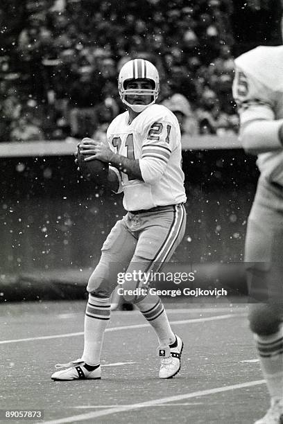 Quarterback John Hadl of the Houston Oilers looks to pass as snow falls during a game against the Pittsburgh Steelers at Three Rivers Stadium on...