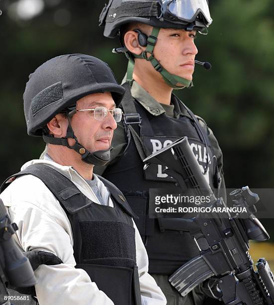 Revolutionary Armed Forces of Colombia member Gerardo Aguilar , a.k.a "Cesar", is being escorted by a Colombian police officer before being...