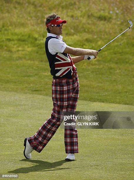 English golfer Ian Poulter plays a shot on the 7th fairway on the first day of the 138th British Open Championship at Turnberry Golf Course in south...