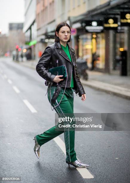 Maria Barteczko wearing black biker leather jacket Acne, glasses, green cashmere sweater Valentino, green jersey track pants Valentino, silver...