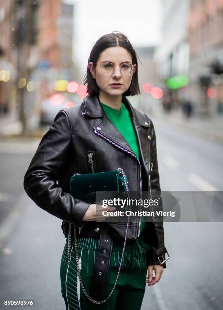 Maria Barteczko wearing black biker leather jacket Acne, glasses, green cashmere sweater Valentino, green jersey track pants Valentino, silver...