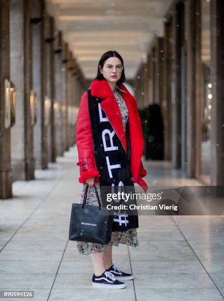 Maria Barteczko wearing red leather shearling aviator jacket Ducie, long floral printed dress Joseph, black shopping bag Balenciaga, wool logo scarf...