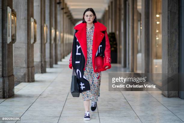 Maria Barteczko wearing red leather shearling aviator jacket Ducie, long floral printed dress Joseph, black shopping bag Balenciaga, wool logo scarf...