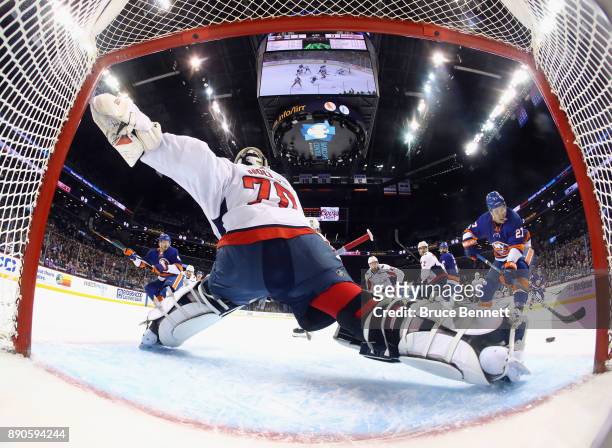 Braden Holtby of the Washington Capitals moves across the crease to stop a first period attempt by Anders Lee of the New York Islanders at the...