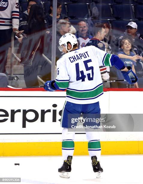 Michael Chaput of the Vancouver Canucks takes part in the pre-game warm up prior to NHL action against the Winnipeg Jets at the Bell MTS Place on...