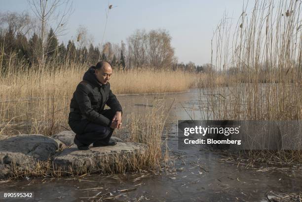 Ma Jun, founder of the Institute of Public & Environmental Affairs, poses for a photograph in a park in Beijing, China, on Saturday, Dec. 2, 2017....