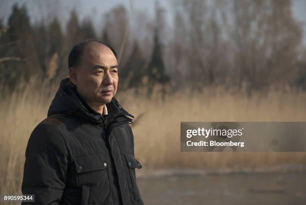 Ma Jun, founder of the Institute of Public & Environmental Affairs, poses for a photograph in a park in Beijing, China, on Saturday, Dec. 2, 2017....