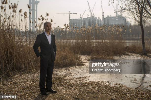 Ma Jun, founder of the Institute of Public & Environmental Affairs, poses for a photograph in a park in Beijing, China, on Saturday, Dec. 2, 2017....