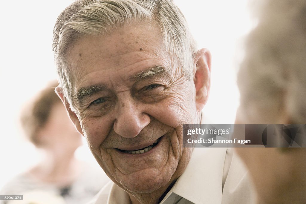 Elderly Man Talking With Woman in Nursing Home 