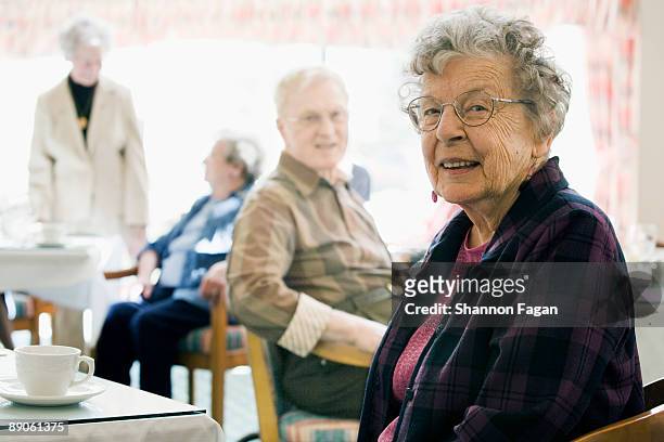 elderly woman in nursing home drinking coffee - rentnersiedlung stock-fotos und bilder