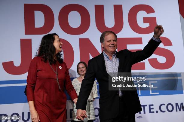 Democratic Senatorial candidate Doug Jones and his wife Louise Jones greet supporters during a get out the vote campaign rally on December 11, 2017...